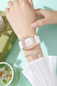 Detail of rose gold octagon watch with diamonds and matching bow bracelet on wrist