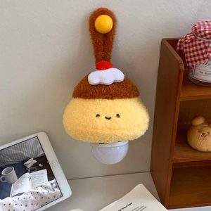 Detail of hanging plush pudding night light with cute cartoon face and warm LED bulb