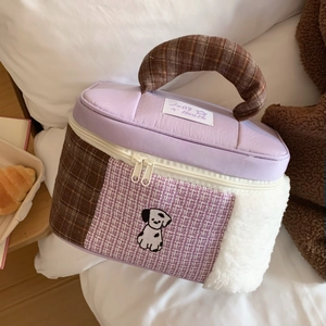 Detail of cartoon patchwork makeup bag with plush texture and cute dog embroidery