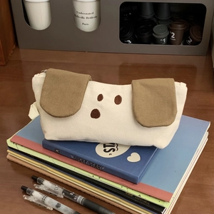 Close-up of white canvas pencil case featuring a cute cartoon dog with brown floppy ears