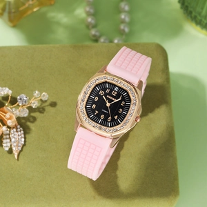 Detail of rose gold square watch case with rhinestone bezel and pink silicone strap