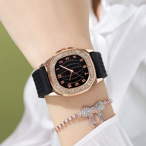 Detail of rose gold rhinestone watch and bow bracelet set worn on wrist elegantly