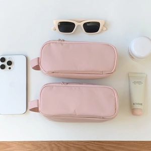 Detail of pink multi-functional pouches showing high capacity with brushes and makeup