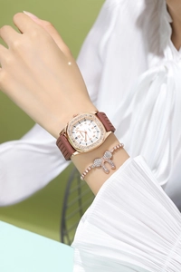 Detail of elegant rose gold square watch with crystal rhinestones and bow bracelet set