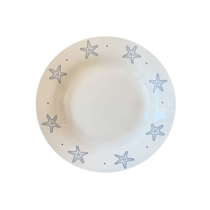 White ceramic plate with blue starfish patterns and dots for dessert and pasta