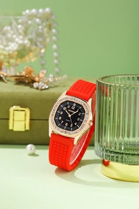 Close-up of luxury women quartz watch with red silicone strap and crystal bezel