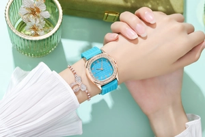 Detail of square rose gold rhinestone watch with sky blue silicone strap and bracelet