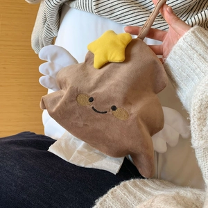 Detail of hanging plush tissue holder with star wings and embroidered smiley face