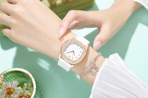 Detail of rose gold square watch with crystal bezel and matching bow bracelet set