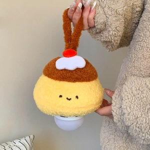Detail of cute pudding-shaped plush night light with cream top and hanging strap detail