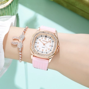 Close-up of a pink silicone quartz watch with rhinestone bezel and bow bracelet