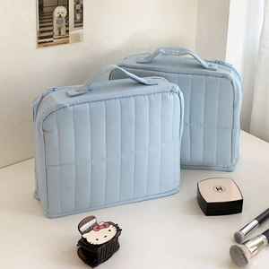 Vertical quilted light blue cosmetic bag set with top handles for travel toiletries