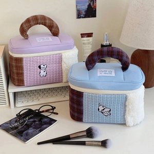 Detail of cartoon puppy embroidery on patchwork tweed and faux fur cosmetic bags