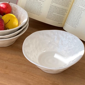 Minimalist white ceramic bowl with rock texture and wavy rim for salad or soup