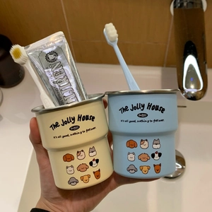 Detail showing cream and blue stainless steel tooth mugs with cute cartoon dog patterns
