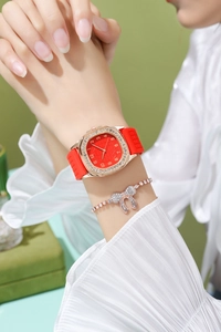Detail of rose gold square watch with rhinestones and matching bow bracelet on wrist