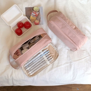 Detail view of pink multi-functional pencil case with internal compartments and elastic slots