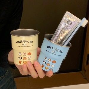 Detail of stainless steel cartoon dog mugs in soft yellow and blue for dental care