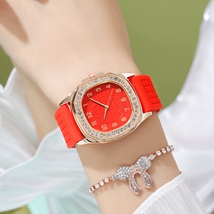 Close-up of red silicone strap quartz watch with rhinestone bezel and matching bracelet