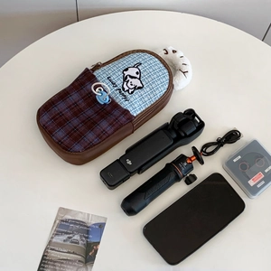 Macro detail of checkered storage case with puppy pattern for DJI Pocket 3 camera gear