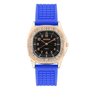 Detail of luxury rose gold square watch with crystal bezel and blue silicone strap