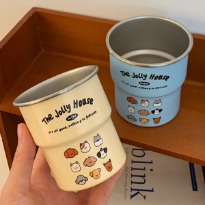 Detail of stacked stainless steel puppy mugs with matte cream and blue finishes