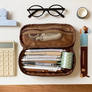 Close-up of brown dual-layer mesh pencil case with large capacity and organized stationery