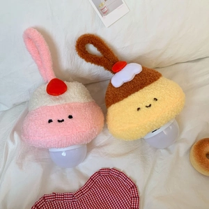 Macro detail of plush strawberry cake and pudding hanging night lights with soft fabric texture