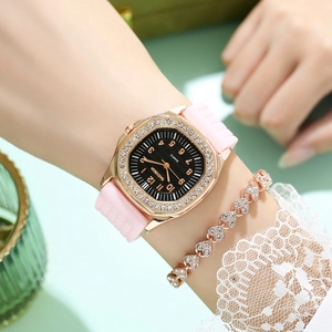 Close-up of luxury rhinestone square quartz watch with soft pink silicone strap and heart bracelet
