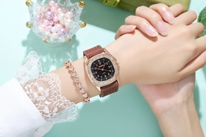 Close-up of luxury square quartz watch with rhinestones and matching heart bracelet