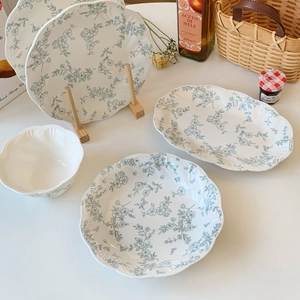 French vintage ceramic dinnerware set with blue floral relief and wavy edge design