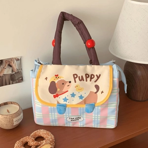 Close-up of pink checkered lunch bag with cartoon puppy print and thick brown handles