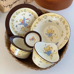 Le Petit Prince themed ceramic tableware set including bowls and plates in warm yellow finish