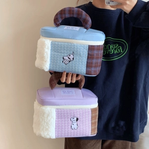 Detail of cartoon patchwork makeup bags with puppy embroidery and fleece texture