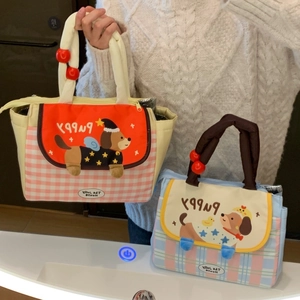 Close-up of cute cartoon puppy lunch bags with checkered patterns and thick handles