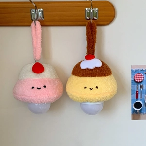 Macro shot of cute cartoon plush hanging night light in dessert shape with embroidery