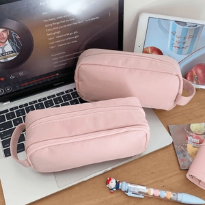 Detailed view of pink multi-layered storage bag with durable handle and dual zippers