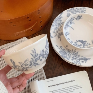 French vintage ceramic dinnerware set with blue bird and floral patterns on cream base