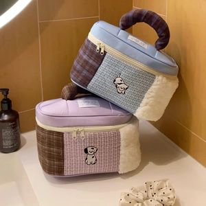 Detail of cartoon patchwork makeup bag with plush texture and sturdy checkered handle