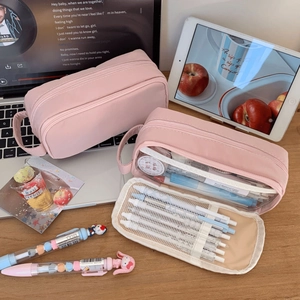 Pink double-layer pencil case detail with multiple compartments and mesh pockets