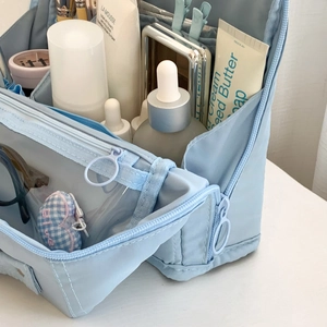 Detail view of large capacity makeup bag with interior compartments and mesh pockets