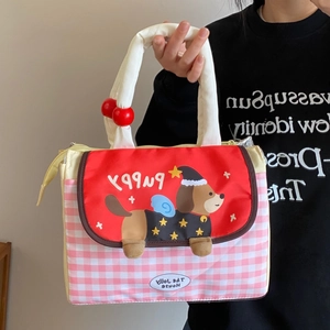 Detail of cute dachshund lunch bag with pink gingham pattern and red puppy print cover