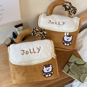 Detail of suede house makeup bag with Jolly embroidery and leopard Hello Kitty design