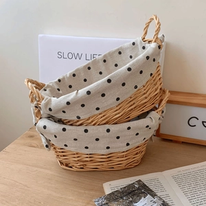 Detail of woven rattan storage baskets with polka dot fabric lining and side handles