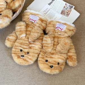 Detail of plush orange tiger print mittens with cute ears and a woven Jolly label