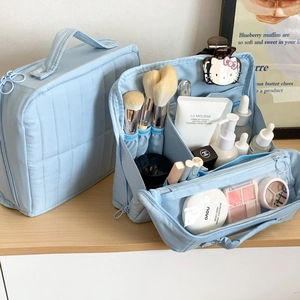 Detail view of large capacity quilted makeup bag with makeup brush slots and dividers