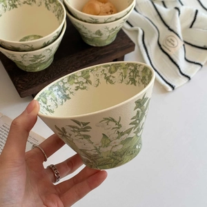 Detailed view of lily of the valley ceramic bowl with scalloped edges and floral print