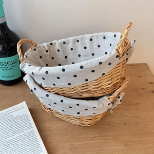 Nesting set of hand-woven wicker storage baskets with black polka dot fabric lining