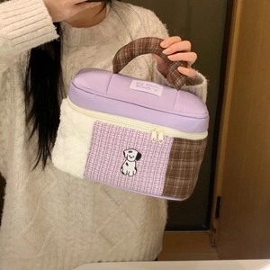 Detail of cartoon patchwork makeup bag with plush fabric and dog embroidery