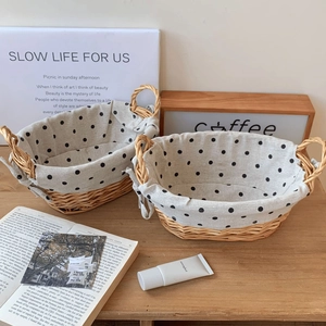 Detailed close-up of woven rattan baskets with black polka dot fabric lining and handles